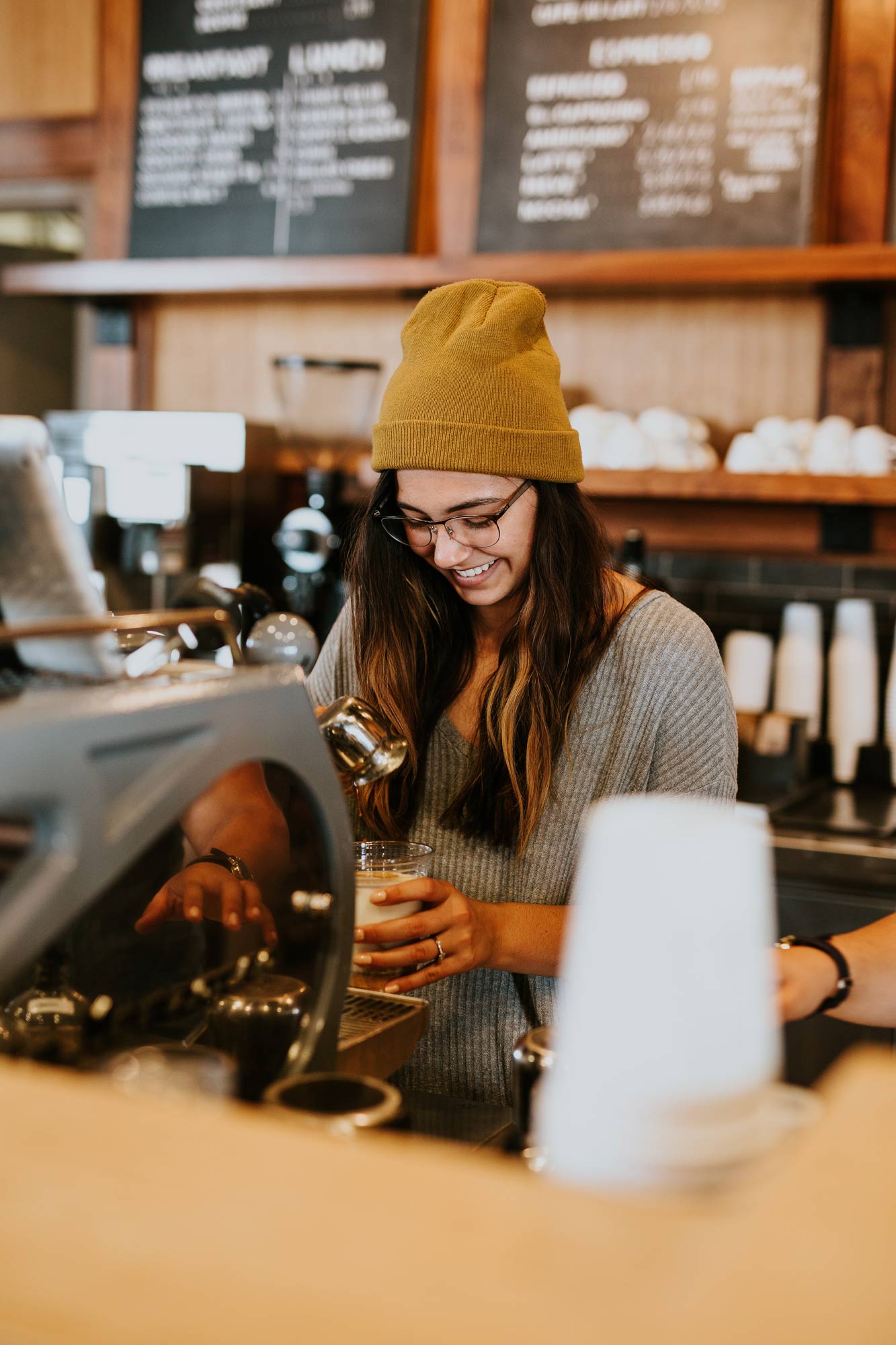 A barista working behind a cafe counter